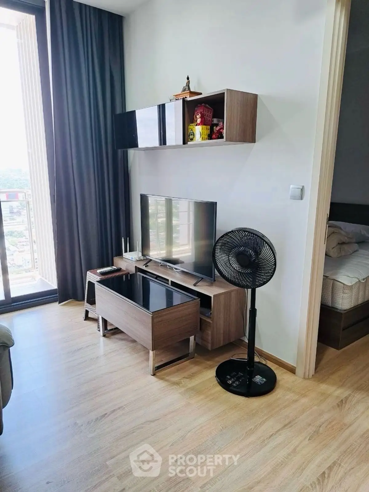 Modern living room with sleek TV stand and balcony view