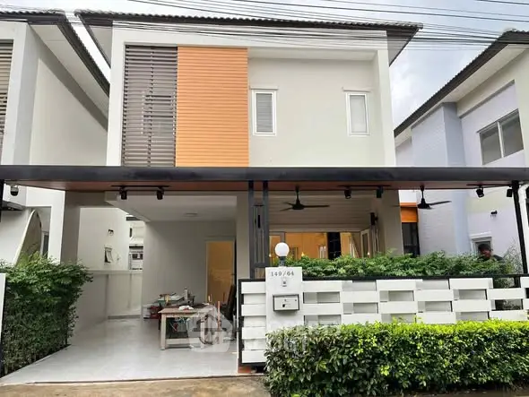 Modern two-story house with stylish facade and lush greenery