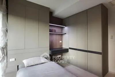 Modern bedroom with sleek built-in wardrobe and cozy bed setup