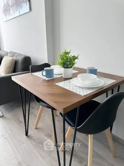 Modern dining area with stylish table and chairs in a cozy living space.