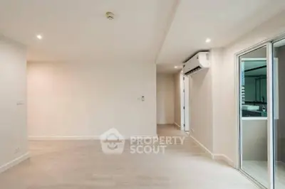 Spacious empty room with air conditioning and sliding glass door, perfect for customization.