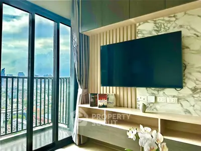 Modern living room with city view and wall-mounted TV, featuring elegant decor and large balcony access.