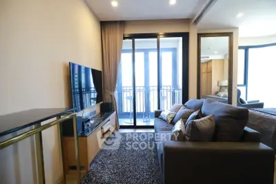 Modern living room with cozy sofa and large TV, featuring a balcony with city view.