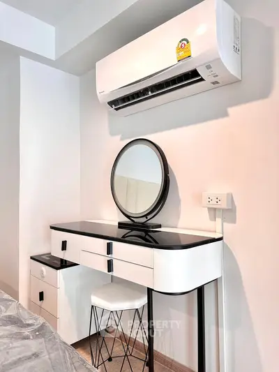 Modern bedroom with sleek vanity and air conditioning unit, perfect for comfort and style.