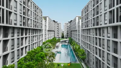 Modern apartment complex with central swimming pool and lush greenery