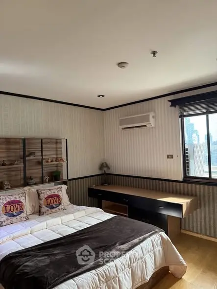 Cozy bedroom with city view, featuring a stylish bed and modern decor.