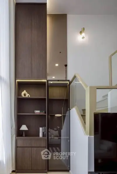 Modern interior with stylish wooden shelving and elegant lighting in a contemporary living space.