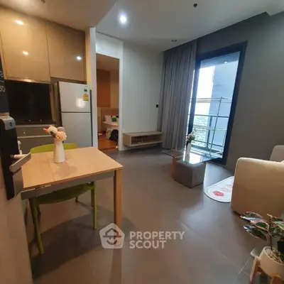 Modern open-plan living room with dining area and balcony access