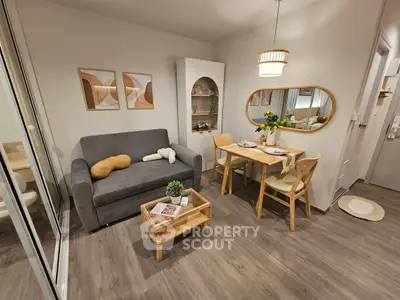 Cozy living room with modern decor, featuring a comfortable sofa, dining table, and stylish wall art.