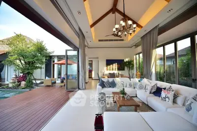 Luxurious open-plan living room with pool view and elegant decor