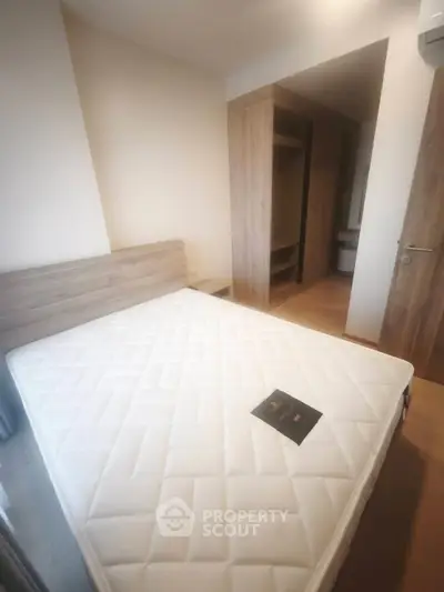 Cozy bedroom with wooden accents and comfortable mattress in modern apartment