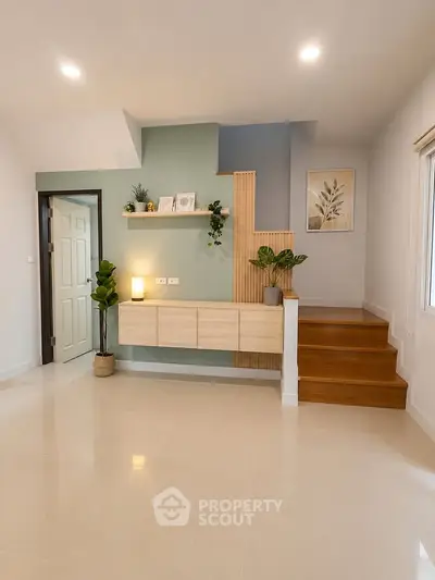 Modern minimalist living room with stylish decor and wooden staircase