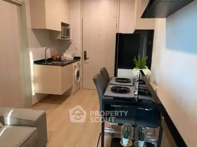 Modern kitchen with dining area and washing machine in compact apartment