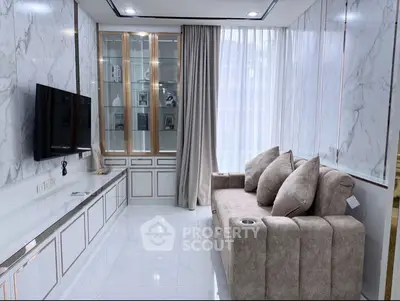 Luxurious living room with marble walls, plush sofa, and built-in TV unit
