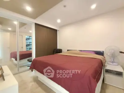 Spacious bedroom with modern decor and ample natural light.