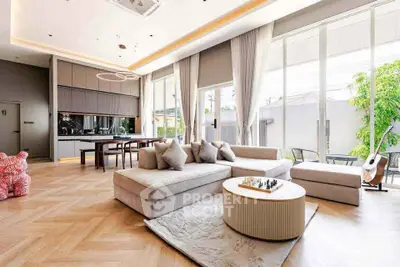 Spacious modern living room with elegant decor and large windows offering natural light.