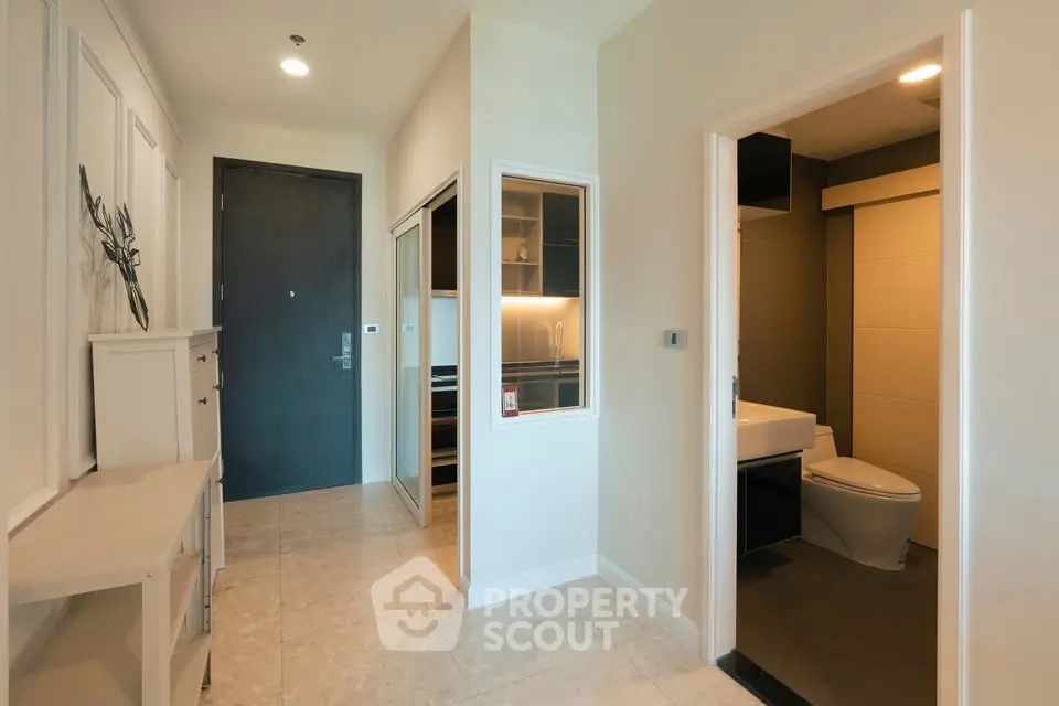 Modern apartment entrance with sleek design and adjacent bathroom