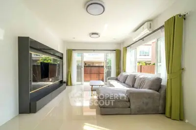 Spacious living room with modern decor and large windows for natural light