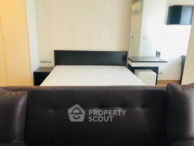 Modern bedroom with sleek furniture and neutral tones, featuring a comfortable bed and stylish decor.