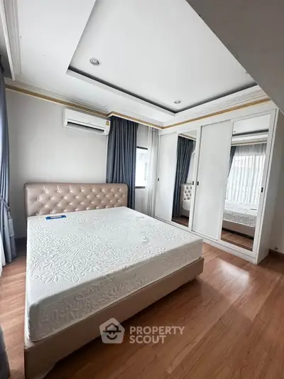 Spacious bedroom with elegant design and ample natural light