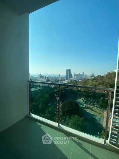 Stunning balcony view overlooking cityscape with lush greenery and skyline.