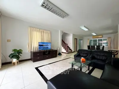 Spacious living room with modern furniture and natural light, perfect for family gatherings.