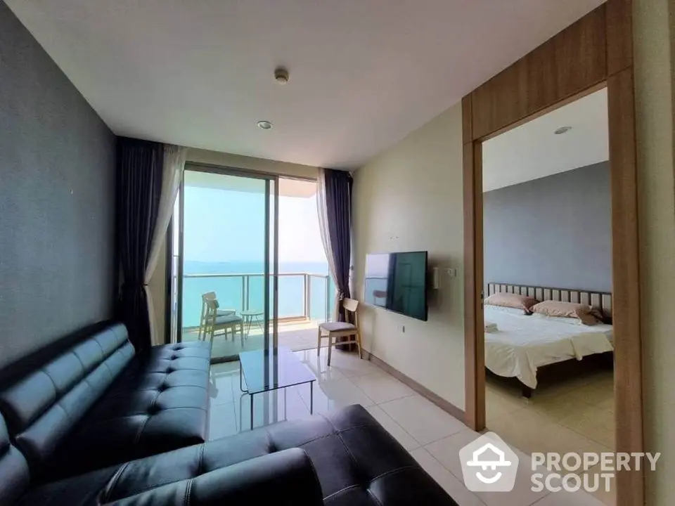 Modern living room with ocean view balcony and adjacent bedroom