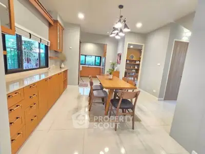 Modern kitchen with wooden cabinets and dining area in open layout