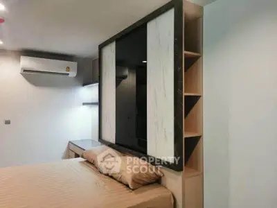 Modern bedroom with stylish partition and air conditioning unit