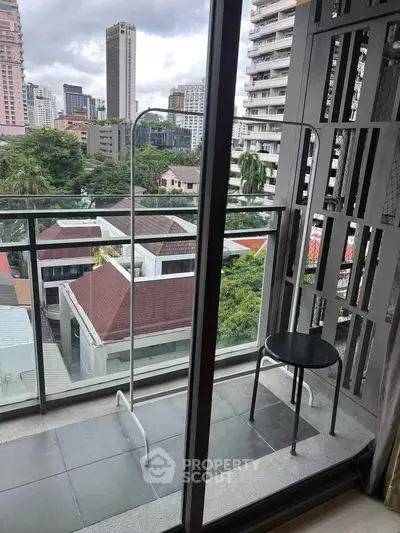Chic urban balcony with cityscape view, perfect for relaxation and enjoying the skyline.