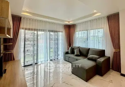 Spacious living room with modern decor and large windows for natural light.