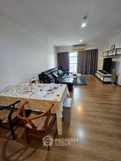 Spacious living room with modern decor and dining area, perfect for family gatherings.