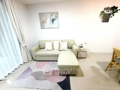 Modern living room with stylish sofa and artistic decor in a cozy apartment setting.