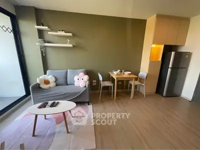 Charming living room with cozy sofa, dining area, and modern kitchen in open layout apartment.