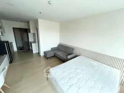 Modern studio apartment with cozy living area and kitchen