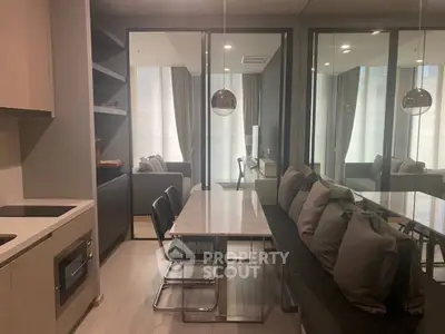 Modern kitchen and dining area with sleek design and cozy seating