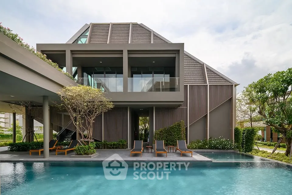 Luxurious modern villa with sleek architecture and private pool, surrounded by lush greenery, offering serene outdoor living.