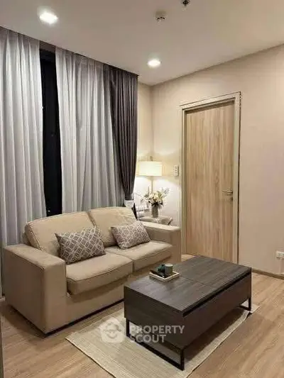Cozy modern living room with beige sofa and elegant decor