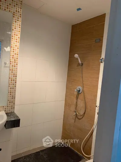 Modern bathroom with sleek shower design and stylish tile accents.