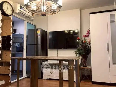 Modern living room with stylish chandelier, wall-mounted TV, and sleek furniture design.