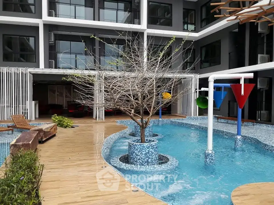 Modern apartment complex with stylish pool and unique architectural design.