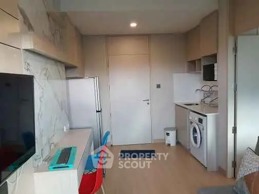 Modern compact kitchen with washing machine and sleek design