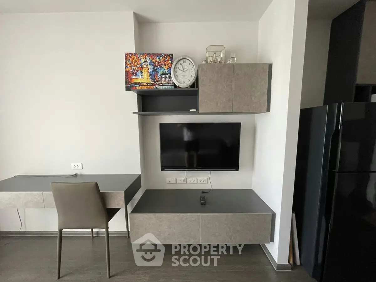 Modern living room with sleek furniture and wall-mounted TV, perfect for contemporary living.