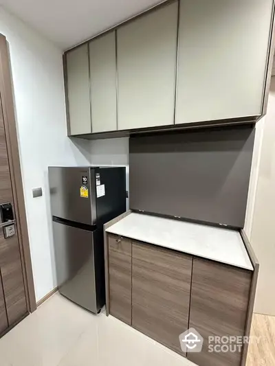 Modern kitchen with sleek cabinets and stainless steel fridge