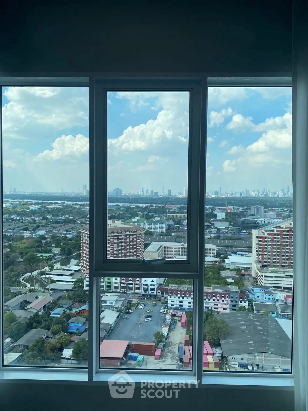 Stunning cityscape view from a high-rise window showcasing urban skyline and expansive horizon.