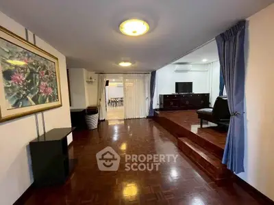 Spacious living room with elegant wooden flooring and stylish decor