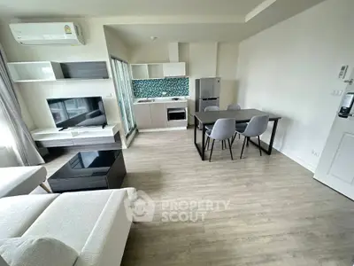 Modern open-plan living room with stylish kitchen and dining area