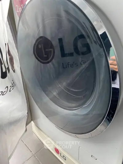 Modern LG washing machine in sleek laundry area, enhancing home convenience and efficiency.