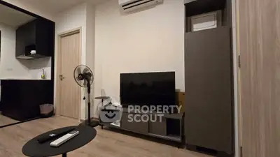 Modern living room with sleek TV setup and air conditioning in stylish apartment.