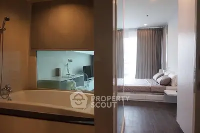 Modern apartment with cozy bedroom and stylish bathroom featuring a bathtub, perfect for urban living.